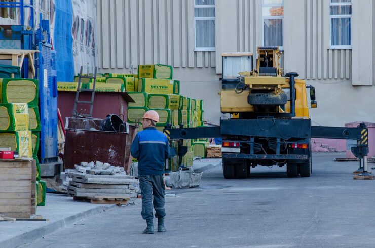 workwear-warming-facade-building-it-is-tower-crane-nearby-is-building-material